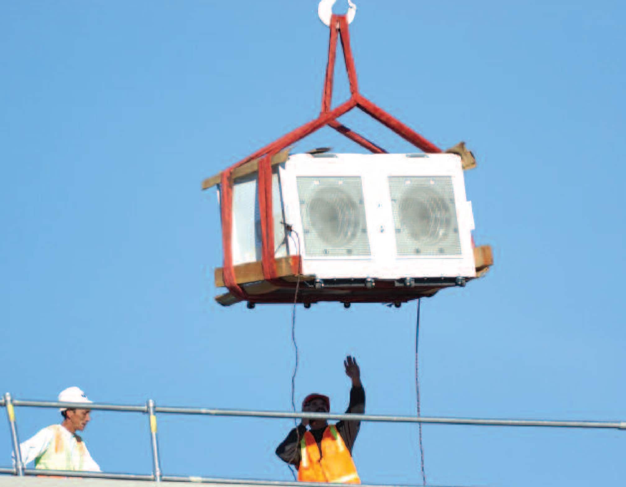 FANWALL cells are lowered by crane into the penthouse equipment room.